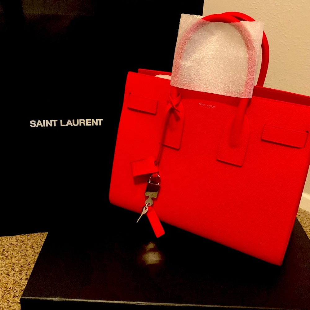 I am Selling a Red Ysl Sac de Jeur bag in Size Small.